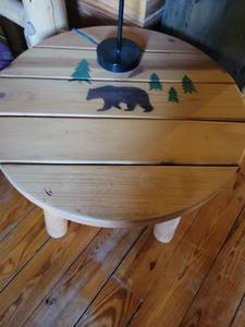 lot 253 image: Rustic Wood Round coffee Table with Bear and Pine Tree Design