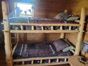 lot 254 image: Log Bunk Bed with with twin mattresses Southwestern Pattern Bedding Set