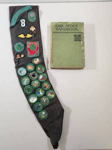 lot 92 image: 1950s Girl Scout Badge Collection with Sash And 1933 Handbook