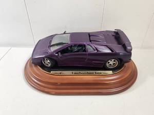 lot 102 image: Maisto Lamborghini Jota Model Car on Wooden Base