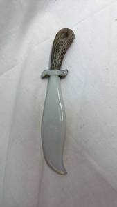 lot 53 image: Milk Glass Decorative Curved Knife with Wood Grain Pattern