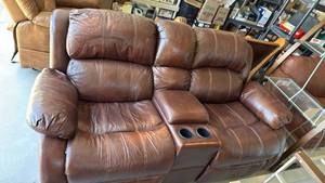 lot 302 image: Durham RockerReclining Sofa with cup holders 36x74x36 seat 19 inches located in garage