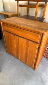 lot 312 image: Oak 2 door cabinet with drawer 36x36x18 located in garage great condition