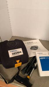 lot 1566 image: Lifepak defibrillator and walking stick