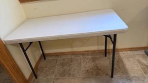 lot 2200 image: Lifetime 4 ft folding table located in basement has walkout