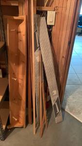 lot 2407 image: Wooden coat rack shelf 50x5, misc pieces of trim and curtain rods located in basement