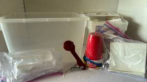lot 3131 image: Tub of plastic ware, cups, napkins and a wine opener