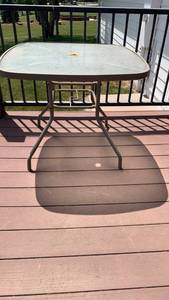 lot 4000 image: Tempered glass patio table 28x34x34 located on back  deck
