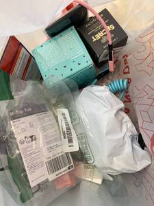 lot 411377 image: 15 Item Mystery Bag (misc. makeup, phone accessories, electronics, toys, stuffed animals, keychains, household items, etc.)