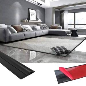 lot 22885 image: 44in Flooring Transition Strips,Flexible Rug Edge Protector for Doorway,Self Adhesive Cuttable Carpet Edge Trim Strip, Flexible Carpet Edging from Carpet to Tile Floor Black - Retail $16