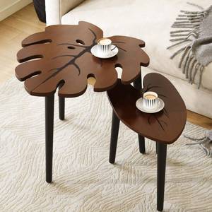 lot 22998 image: BAMEOS Monstera Leaf Nesting Tables Set of 2, Small Side Tables f Set with Leaf Vein Pattern, Modern Wooden CoffeeTables for Living Room Bedroom Apartment Balcony Yard - Retail $60