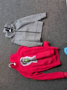 lot 28 image: Grinch Christmas Hoodie and Gray Zip-Up Sweater Bundle size S and M