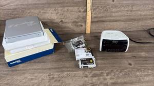 lot 311 image: Office Electronics Bundle - Stamps.com Scale, Sony Alarm Clock, Epson Ink Cartridges