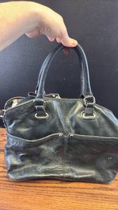 lot 5443 image: Tignanello Black Leather Handbag with Colorful Striped Lining
