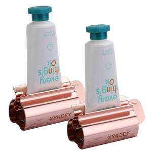 lot 386 image: XYKEEY Toothpaste Tube Squeezer - Set of 2 Toothpaste Squeezer Rollers, Metal Toothpaste Tube Wringer Seat Holder Stand (Coral) - Retail $12