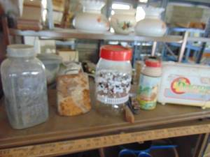 lot 4922 image: Shelf contents-cowbell, Dr. Kit, Thermos