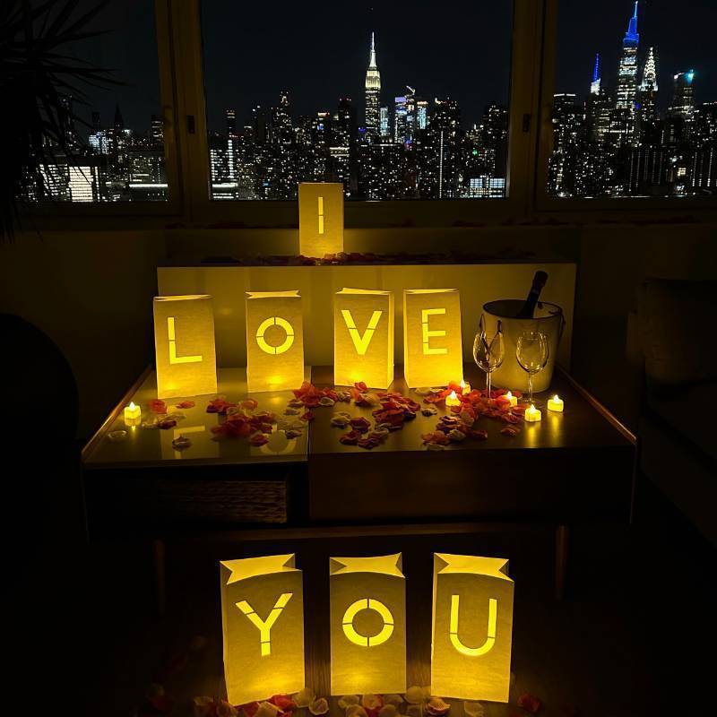 lot 50821 image: WYMM I Love You Light Up Letters with 30 Tea Lights Candles and 1000 Red & Pink Rose Petals - Luminary Bags for Anniversary Decorations, Valentines Day Decorations & Romantic Bedroom Decor - Retail $35
