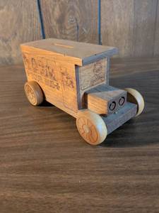 lot 32 image: Wooden bank Tour Bus Toy with Character Engravings