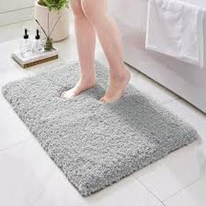 lot 2167 image: Gray fuzzy bath mat 2 ft by one foot and a half