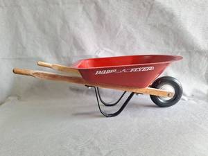 lot 61 image: Vitage 16 Inch Radio Flyer Red Metal Wheelbarrow with Wood Handles