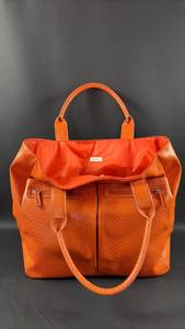 lot 176 image: Neiman Marcus Orange Vegan Leather Snakeskin Pattern Tote Bag with Dual Handles and Zipper Pockets