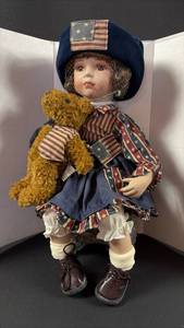 lot 179 image: Vintage Americana Porcelain Doll with Patriotic Outfit and Teddy Bear 12 inches tall Seated on Included Stool. Amazing Details