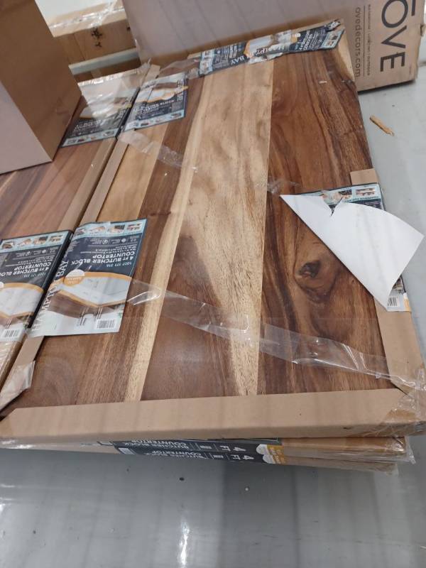 lot 14051 image: Hampton Bay 4 ft. L x 25 in. D Finished Saman Solid Wood Butcher Block Countertop with Live Edge Retail $349