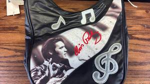 lot 5378 image: Elvis Presley Black Leather Purse with Musical Note Design