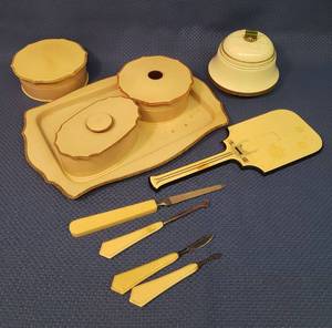 lot 21 image: Vintage Bakelite  Dresser Set, Hand Mirror, Pedicure Tools & Button Hook, and Antique Metal Over Wood Music Box Dresser Powder Box