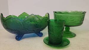 lot 33 image: Vintage Anchor Hocking Green Sandwich Glass Tumbler 4in T & Custard Liner 4.5in W, Vintage Jeanette Glass Flashed BlueGreen Lombardi Footed Oval Fruit Bowl 10in L x 7in W, and Vintage E.O. Brody Green Glass Pedestal CandyFruit Dish 7in W x 5.5in T