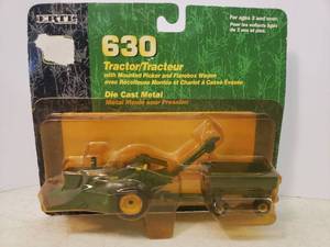lot 38 image: Collectible 2001 Unopened ERTL Die Cast 164 Scale - John Deere 630 Tractor #15086 with Mounted Picker and Flarebox Wagon - in Original Blister Package