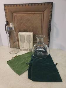 lot 55 image: Velvet Wine Bottle Bags, Crystal Wine Decanter 7.5in T, Vintage Cocktail Shaker 10.75in T, Lets Drink Wine Wall Decor 5in W x 7in T, and Large Metal Serving Tray 16in X 16in