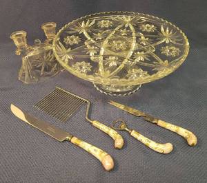 lot 57 image: Anchor Hocking Glass Early American Prescut 2 piece 13 12 W Footed CakeTorte Plate, Matching Candle Holder, and Antique Hand Painted Porcelain Handle 4 Pc Serving Utensil Set - Stamped Sheffield England