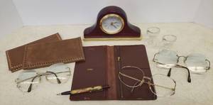 lot 66 image: Pair Vintage Glass Eye Washers, 1970s Eye Glasses, Vintage Leather Wallets, Old Advertising Mechanical Pencil, and Small BO Desk Clock