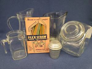 lot 70 image: Vintage Glass Pitchers, Aluminum Measuring Shaker Cup, Old Lidded Candy Jar, and Unused Box of 1950s Flex-Straw Waxed Paper Drinking Straws