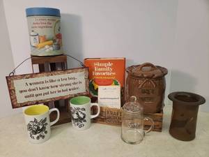 lot 77 image: Antique Wood Kraft Cheese Box, Small Wood Crate, City Bakery Card - Lindsborg, KS, Mugs, Pottery Canister, Stoneware Vase - 5in T, Cookbook, Glass Syrup Pitcher, Metal Sign & Tin