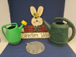 lot 91 image: Custom Painted Wood Bunny Welcome Sign 19in T, Bunny Friendship Stepping Stone 10in W, and 2 Vintage Plastic Watering Cans - Tallest is 13.5in T