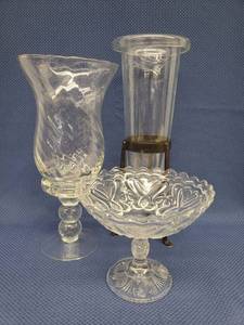 lot 110 image: Vintage Swirl Glass Candle Lantern with Double Ball Pedestal 13.25in T x 6.25in T, Pressed Glass Pedestal Presentation Bowl 7.5in W x 6.5in T, and Modern Roll Top Class Vase in Black Wrought Iron Stand 5.5in W x 15.5in T