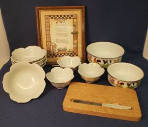 lot 114 image: Country Barn Enamelware Mixing Bowls largest is 7.5in w x 3in T, Burl Wood Cutting Board with Bakelite Handle Knife, Pier 1 Porcelain Flower Salad & Berry Bowls, and 8in x 10in Framed Kitchen Blessing Wall Art