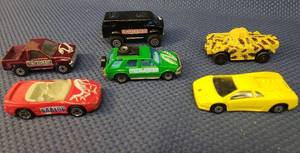 lot 154 image: Vintage Die-Cast Car Toys 1981 Matchbox Stegasurus 4x4 Van, 1991 Matchbox Hadrosaur Pickup, 1973 Matchbox Camo Weasel Battle Tank, 1994 Matchbox Brontosaurus, 1994 Matchbox 3000GT Spyder Raptor, and 1997 Maisto 30th Anniversay Edition Lamborghini Diablo