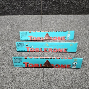lot 465 image: Lot of 3 TOBLERONE Milk Chocolate Bar with Salted Caramelized Almonds and Honey and Almond Nougat, Bulk Chocolate, 3.52 oz Bars BB March 25, 2026