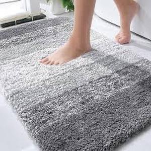 lot 1107 image: Gray fuzzy bath mat approximately 2 and 12 ft by 1 and 12 ft