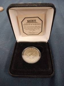 lot 60499 image: 1981-S Susan B. Anthony proof dollar coin packaged by the First Commemorative Mint