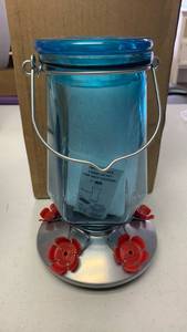 lot 18 image: Perky-Pet Lavender Field Top-Fill Glass Hummingbird Feeder with a 16 oz capacity and five feeding ports. appears to be used