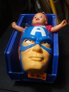 lot 22735 image: Toys with bag of dinosaurs and a doll and captain america head