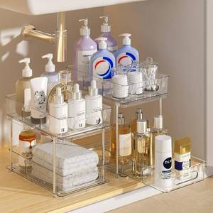 lot 589 image: Delamu 2 Tier Under Sink Organizer Bathroom, Bathroom Cabinet Organizer with Snap-Lock Design and Hooks, Pull Out Storage with Movable Dividers, for Countertop, Kitchen and Pantry (Clear, 2 Pack) - Retail $40