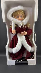 lot 1 image: New Electric 24 Inch Christmas Carol Singer Doll with Candle and Motion