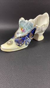 lot 23 image: Vintage German porcelain shoe featuring hand-painted floral accents, gold trim, and flow blue details, often found in Victorian-style home decor collections.