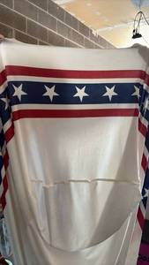 lot 26 image: 4foot Folding table stretch table cover with Stars and Stripes Hem and Large Lot of Flag Decorations and Tinsel Banner