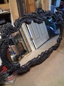 lot 162 image: Ornate Black Oval Mirror with Floral Carved Frame